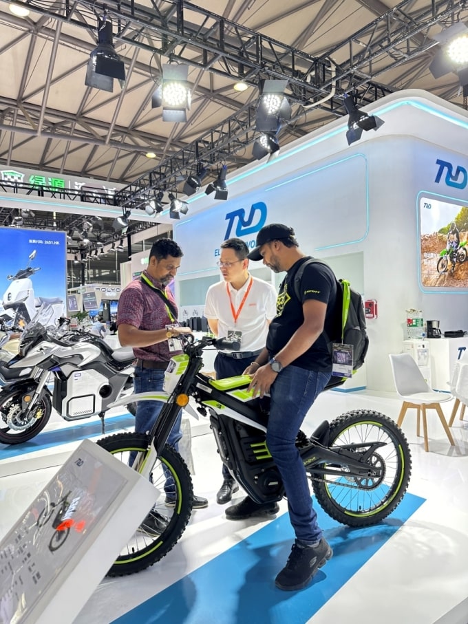 Visitors inspect motorcycles at the T&D booth